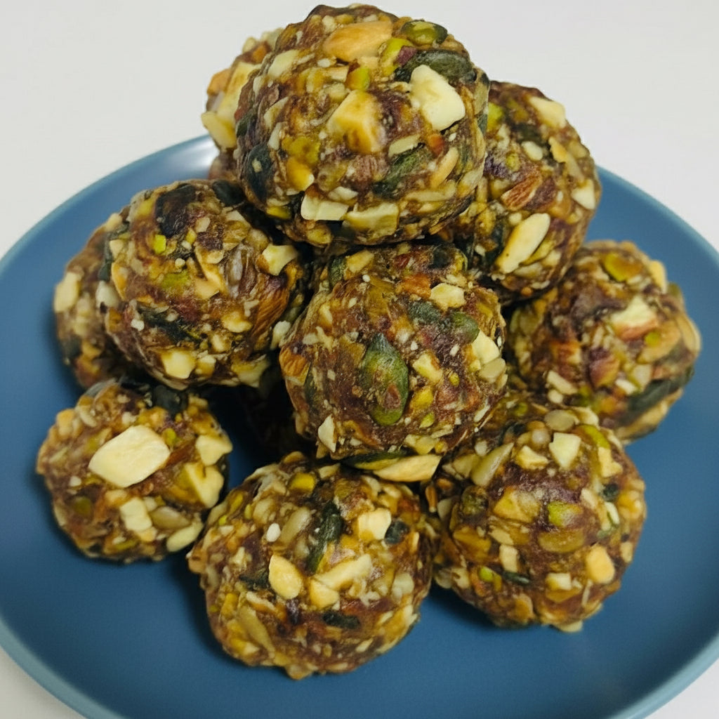 Nuts and seeds energy balls on a white plate